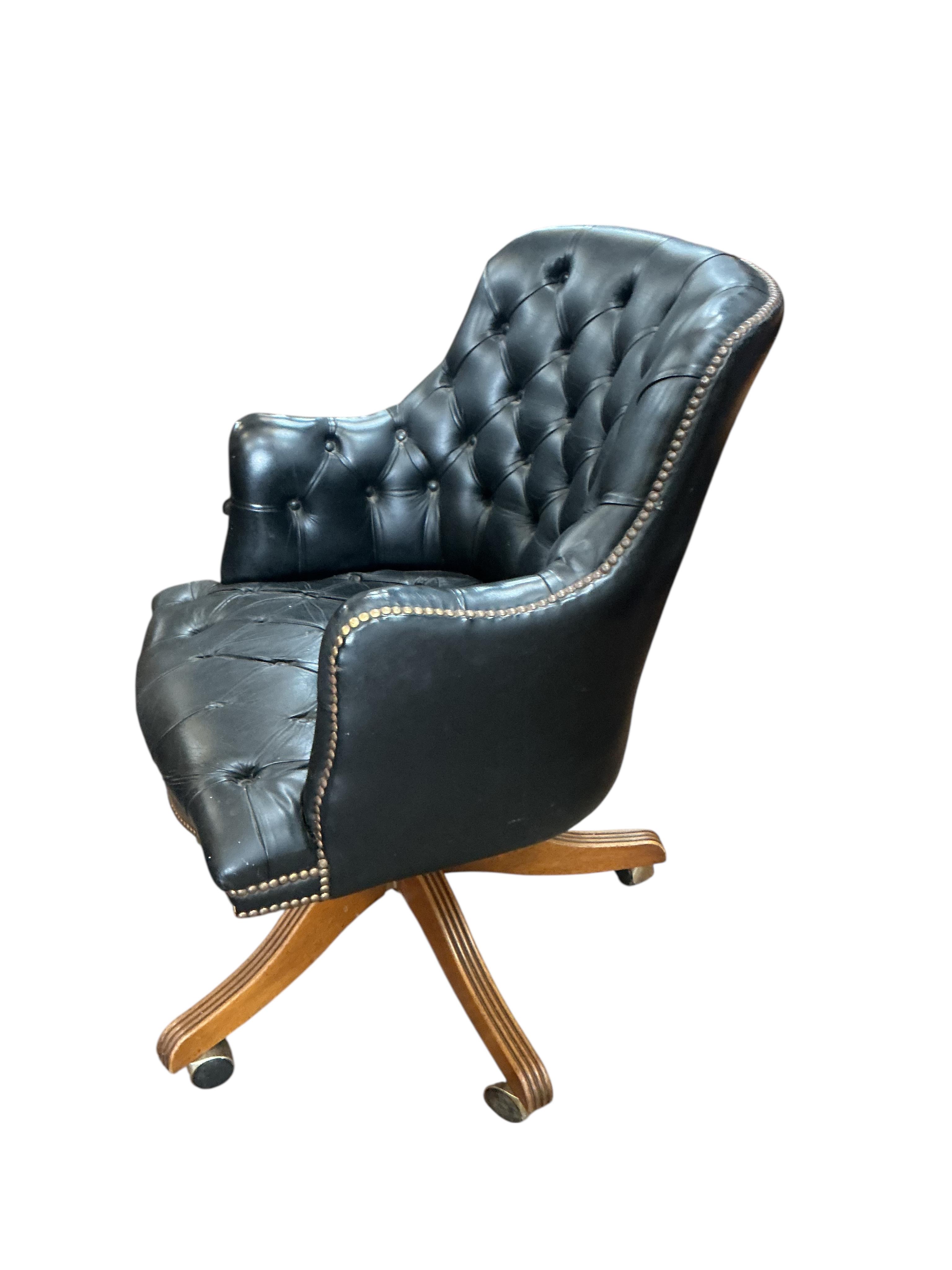 A buttoned leather swivel desk chair